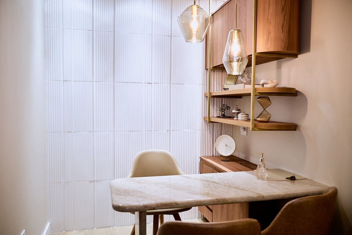 Consultório da Zay com mesa de mármore e luz suave